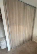 Cramona Oak wood plain panel doors with matt silver frames, fitted in Ingleby Barwick